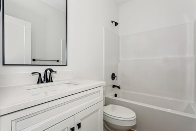 Bathroom with shower / washtub combination and vanity