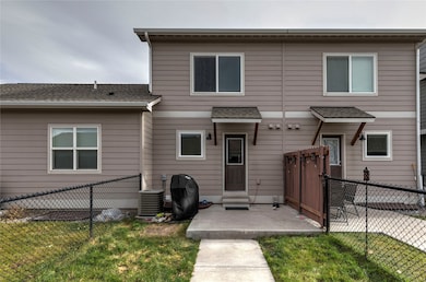 View of front facade featuring a patio area, central AC unit, and a front yard