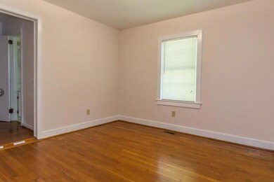 Empty room featuring wood-type flooring