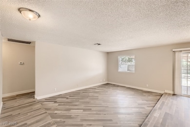 Spare room featuring light wood-style floors and a