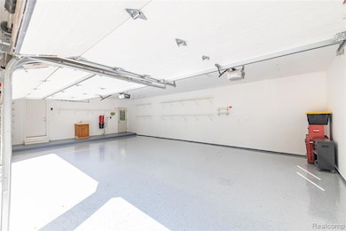 Garage with a central vacuum unit and a garage door opener