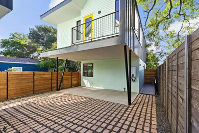 Back of house with a balcony, a fenced backyard, 