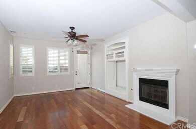 Large living room with a fireplace, shutters and c