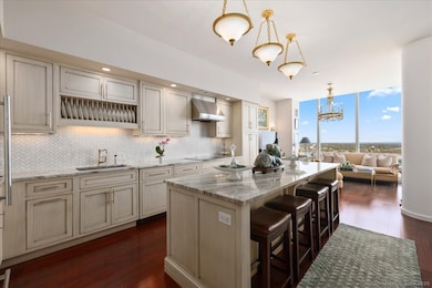 State of the art chef's kitchen with top of the line appliances, cabinetry and stone countertops, is a perfect space for entertaining with these amazing views and access to the private rooftop terrace