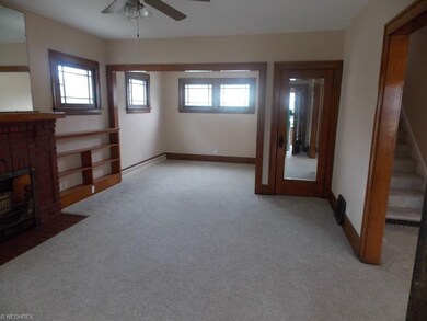 Living room with built-in bookshelves and fireplac