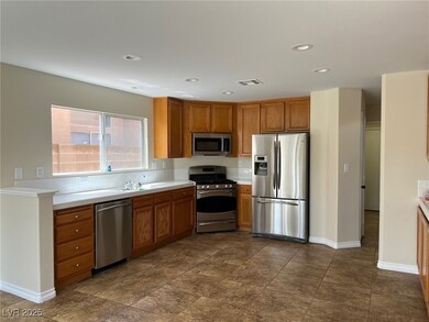 Kitchen with light countertops, stainless steel ap