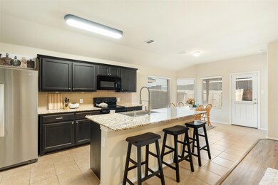 Kitchen featuring an island, and granite counterto