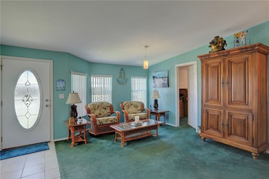 Sitting room with carpet floors and tile patterned floors