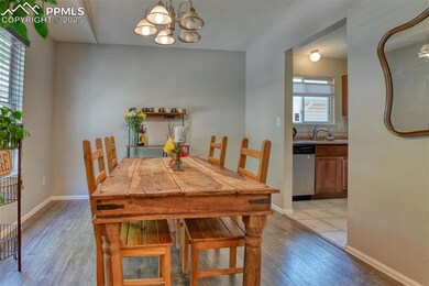 Dining room with light wood-style flooring and a chandelier