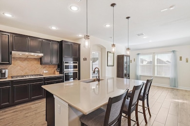 Kitchen featuring hanging light fixtures, a kitche