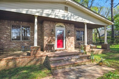 Entrance to property with brick siding and covered