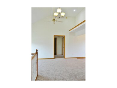 The great room features a vaulted ceiling, ceiling