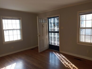 Foyer with dark hardwood / wood-style flooring and