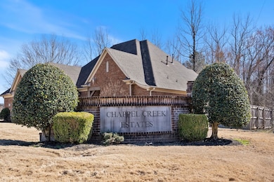 Community / neighborhood sign featuring fence