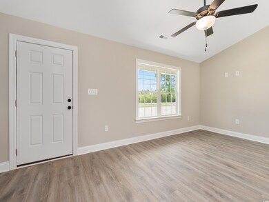 Unfurnished room with visible vents, baseboards, light wood-type flooring, and a ceiling fan