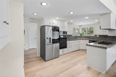 Open, bright, kitchen with new refrigerator.