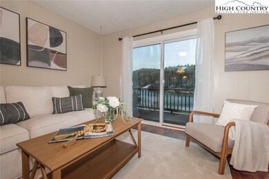 Living room offers beautiful views of Ashe Lake