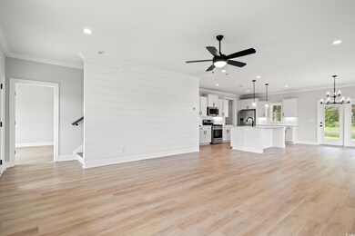 Unfurnished living room featuring crown molding, c