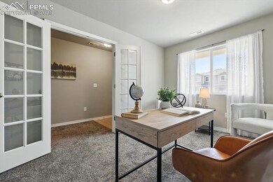 Home office with carpet and baseboards