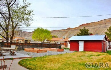 Landscaped yard with raised boxes for gardening, f