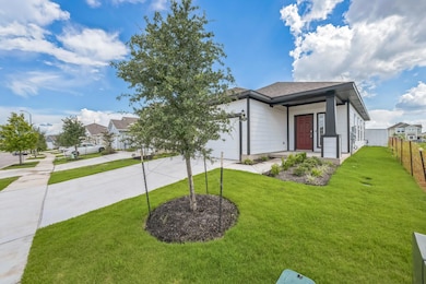 View of front of home featuring driveway and a ga