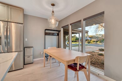 Dining space featuring light wood-style floors and baseboards