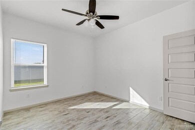 Empty room with light wood-style floors and a ceiling fan