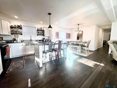 Kitchen featuring open shelves, hanging light fixtures, white cabinetry, dark wood-style floors, and recessed lighting