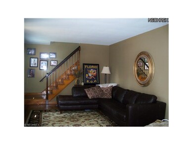 Living room featuring hard wood flooring is open t