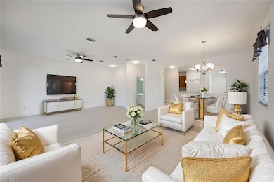 Living room featuring ceiling fan with notable cha