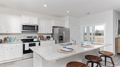 Kitchen featuring stainless steel appliances, ligh