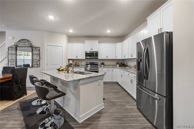 Kitchen featuring light stone counters, a kitchen