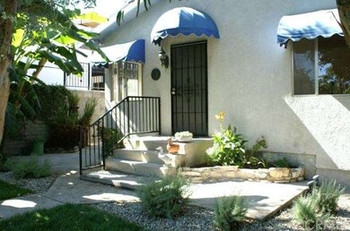 FRONT DOOR ENTRY WITH AWNINGS SURROUNDED BY CONCRE