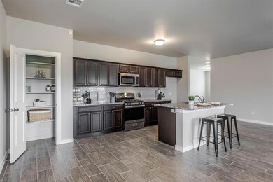 Kitchen with a breakfast bar area, stainless steel