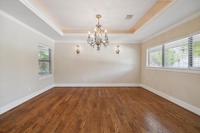 Dining Room with beautiful hardwood floors, coffer