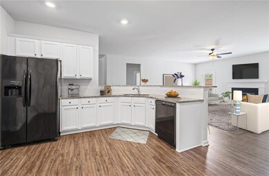 Kitchen featuring a sink, a peninsula, a ceiling f