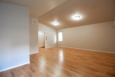 View of large living room with vaulted ceiling.
