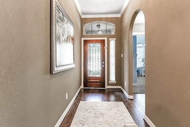 As you enter, you're greeted by a spacious foyer. To the right, a hallway leads to the guest bedroom area, featuring two guest bedrooms with a shared bathroom between them.