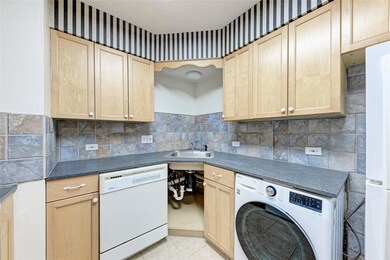 Laundry room featuring a sink, light tile pattern