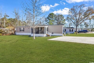 Rear view of property with a sunroom, a yard, and 