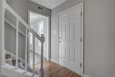 Foyer with Hardwood Floors, Coat Closet and Half B