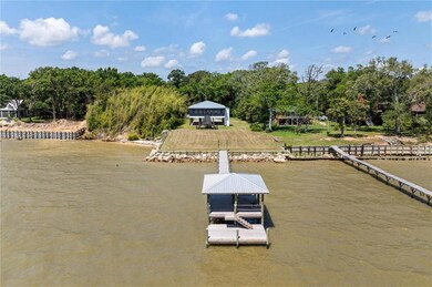 View of the new dock and pier and the back of the home that faces the water