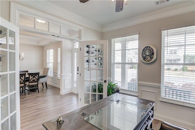 view of foyer and dining room from the private office with french doors.