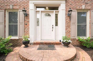 Entrance to property featuring brick siding