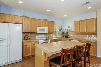 Kitchen features upgraded warm tile counter tops a