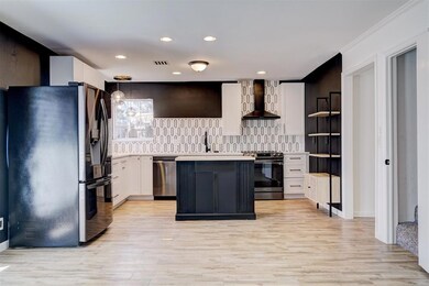 Kitchen featuring tasteful backsplash, light count