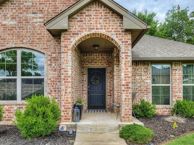 Property entrance with brick siding and roof with shingles