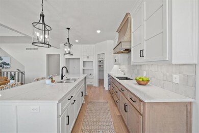 large island with quartz counters and painted cabinets