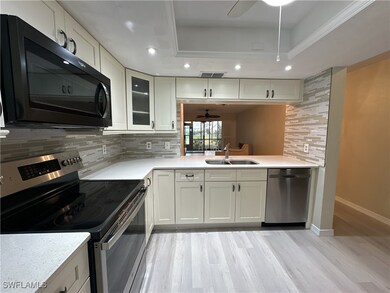 Kitchen featuring stainless steel appliances, back