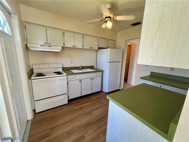 Kitchen featuring white appliances, cream cabinets